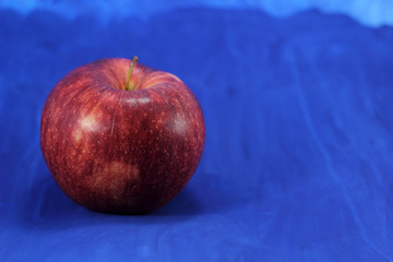 Gala apple on blue background