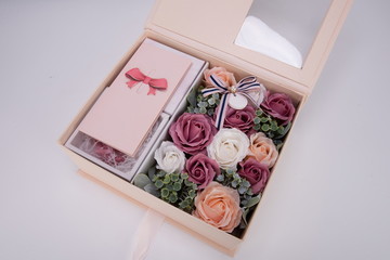 Colorful rose flower gift box with fluorescent lights around. It's a good way to propose