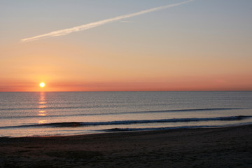 Fishermen on the beach groyne at sunrise,