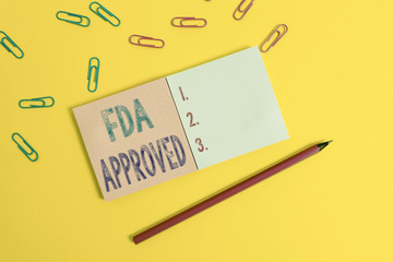 Word writing text Fda Approved. Business photo showcasing FDA agreed the product or formula is safe and or effective Colored square blank sticky notepads pencil clips plain color background