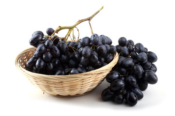 Black grape on wicker plate
