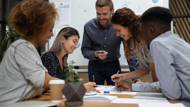 Happy Diverse Employees Working With Legal Documents At Meeting In Boardroom Close Up, Smiling Businesspeople Reading Financial Report, Project Statistics, Sharing Startup Ideas At Briefing In Office