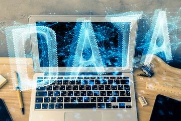 Double exposure of desktop computer and technology theme hologram. Concept of software development.