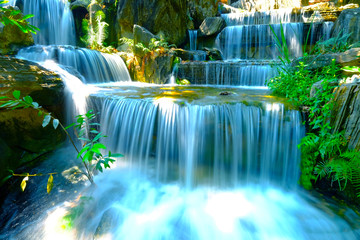 Low speed shutter or long exposure on natural waterfall in the middle of forest