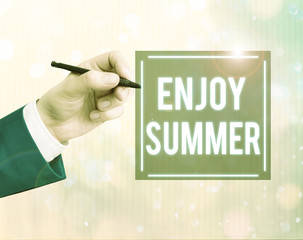 Conceptual hand writing showing Enjoy Summer. Concept meaning taking a break from school and...