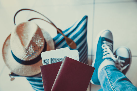 Woman Holding Passport With Boarding Pass Close Up At Airport