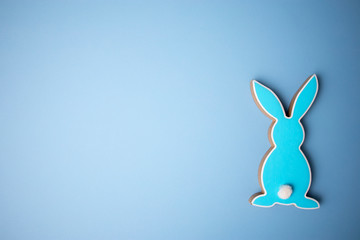 Blue wooden flat easter bunny lies on a blue