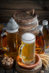 Light frothing beer in a glass, on an old background.