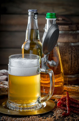 Light frothing beer in a glass, on an old background.