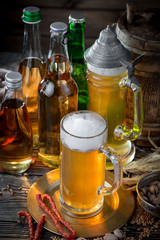 Light beer in a glass, on an old background.