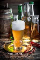 Light beer in a glass, on an old background.