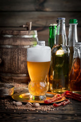 Light beer in a glass, on an old background.