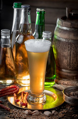 Light beer in a glass, on an old background.