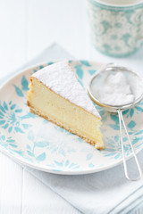 Piece of cheese cake on bright background.