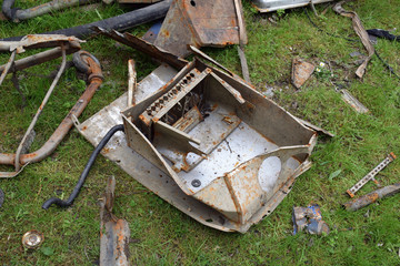 Broken Electronic Equipment Discarded on Grassy in Field