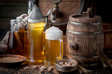 Light frothing beer in a glass, on an old background.
