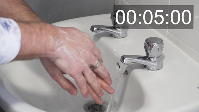 Coronavirus disease - Young man washing hands to counter