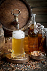 Light frothing beer in a glass, on an old background.