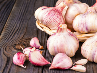 Garlic cloves and garlic bulb on a old wooden table