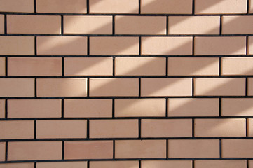 Yellow and brown ceramic brick masonry, house lining, embroidery, background, texture, construction season