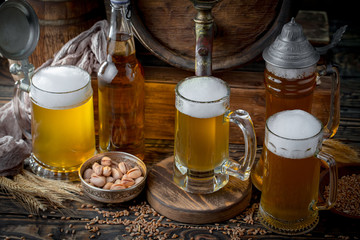 Light frothing beer in a glass, on an old background.