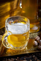 Light beer in a glass, on an old background.