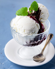 Homemade Organic Vanilla Ice Cream with Jam and Mint Blue Background Tasty Ice Cream Vertical