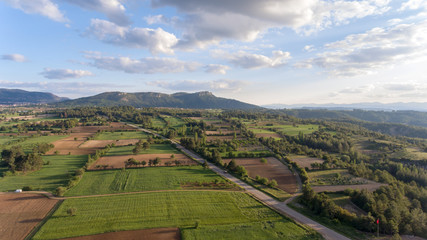 green fields mountain and cloudy sky