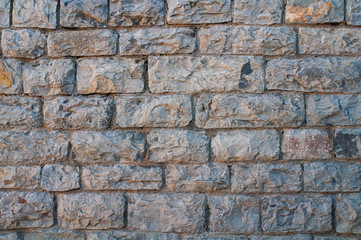 textured wall of gray brick for background
