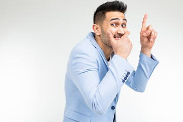 funny gentleman covers his mouth with his hand on a white studio background