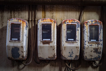 Old street electric meters. In electricity meters flaking paint. Electric energy. Accounting for electricity consumption in Japan. Electrification. Instrument for accounting electrical in Tokyo