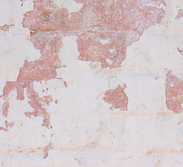 old plaster, light wall with white paint with beige and coral color.