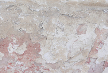 old plaster, light wall with white paint with beige and coral color.