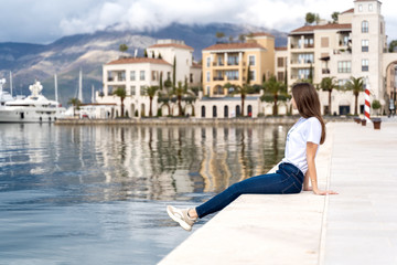 Fototapeta na wymiar Young woman enjoying sea view in a marina port Montenegro