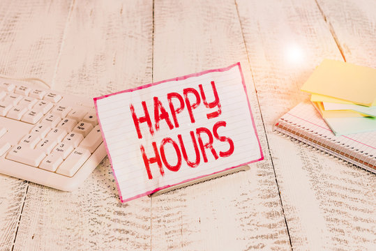 Handwriting text writing Happy Hours. Conceptual photo when drinks are sold at reduced prices in a bar or restaurant Notepaper stand on buffer wire in between computer keyboard and math sheets