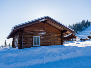 Alpine-style hotel in the ski resort Gornaya Salanga. Chalet in the snow. Winter day