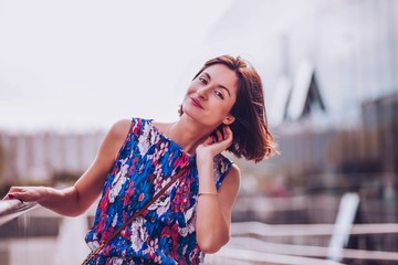 Portrait of young woman that enjoys  walk in the city park