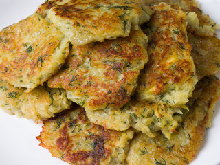 Potato pancakes Draniki on a white plate. Russian, Belorussian and Ukrainian cuisine. Close-up