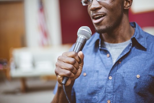 African-American male talking on the microphone at the church