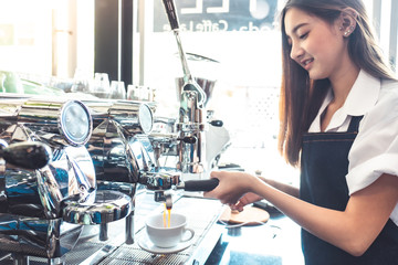 Pretty young asian waitress standing arms crossed in cafeteria.Coffee Business owner Concept. ...