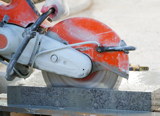 Worker cutting stone block by cutter machine