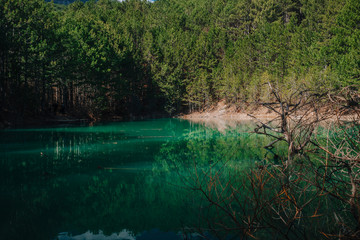 Lake, turquoise water color, mysterious lake in the mountains of Crimea, reflections in the water.