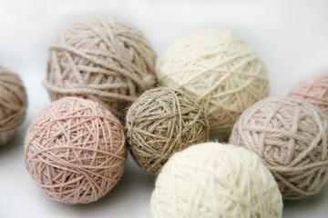 Balls of natural yarn in different colors on a white background. Isolated