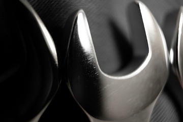 Macrophotography of a set of spanners on a dark background