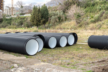 Big plastic tubes on road works, horizontal, no people