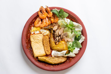 Javanese dish of fried shrimp, tempeh, tofu, eggs, beef to be served on red chili paste and fresh vegetables aside.