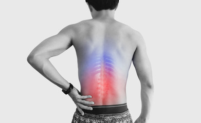Lower back pain. Shirtless man touching his back with red highlight, on white background