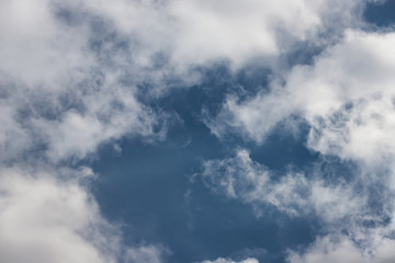 Light fluffy white clouds on a blue sky