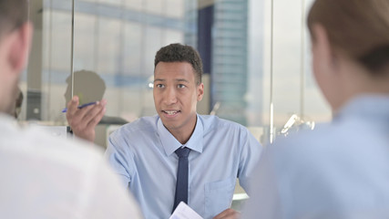 The Business Team getting Argument from African Businessman on Office Table