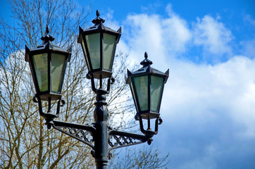 Fototapeta na wymiar old street lamp on background of blue sky